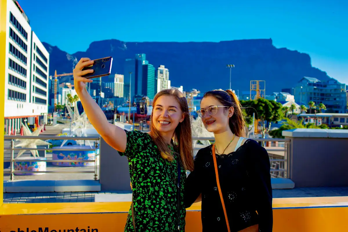 tourists taking pictures at the base of table moutain in capetown south africa
